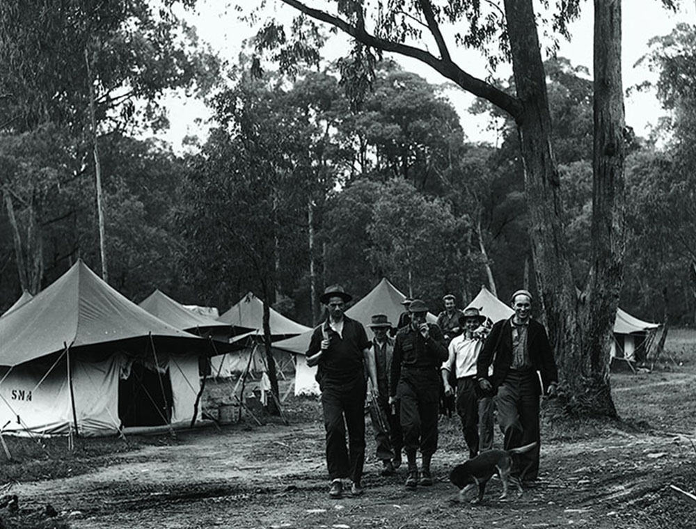 Canvas tents and men at a Snowy Mountains temporary camp