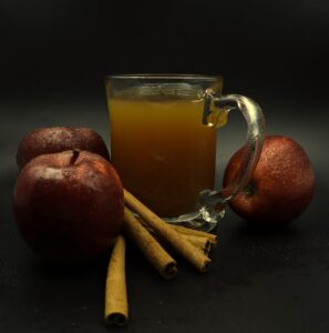 jug of cider with apples