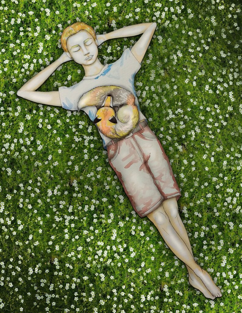 boy lying on grass with fox on his stomach