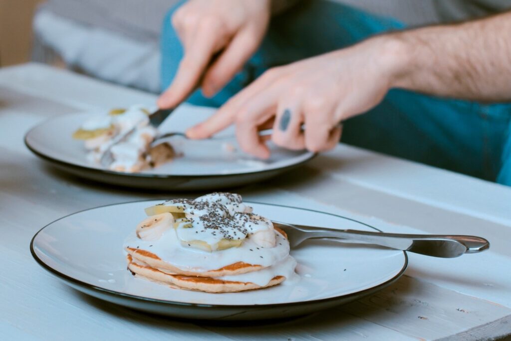 Young man eating eggs