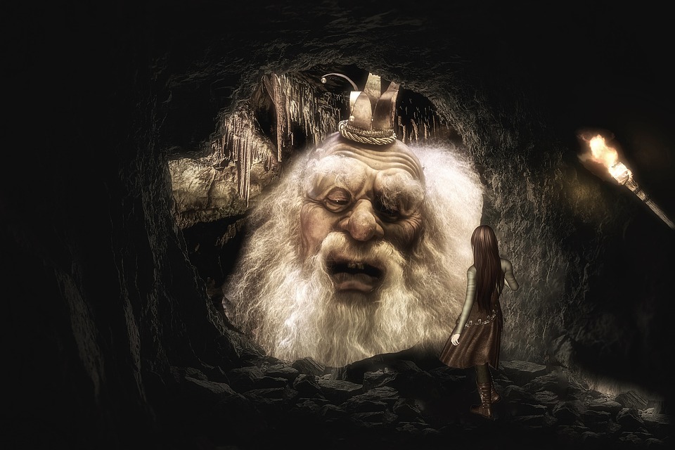 Ancient white bearded character peering from a cave