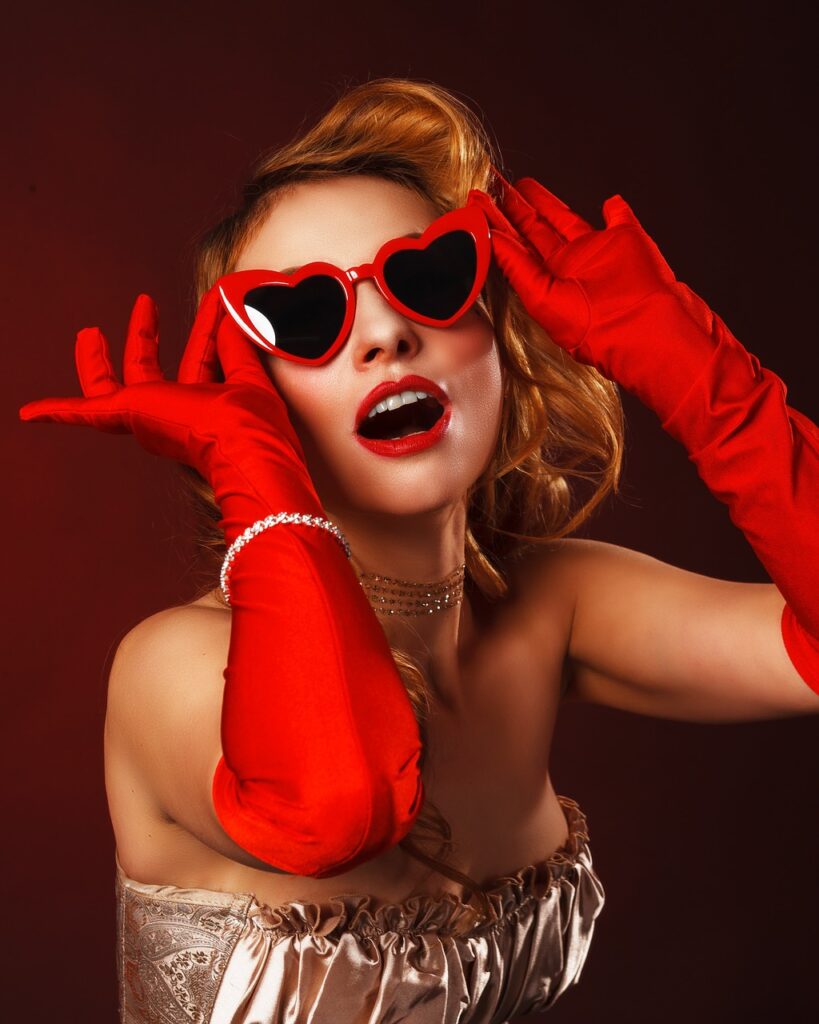 actress with red sunglasses and red gloves