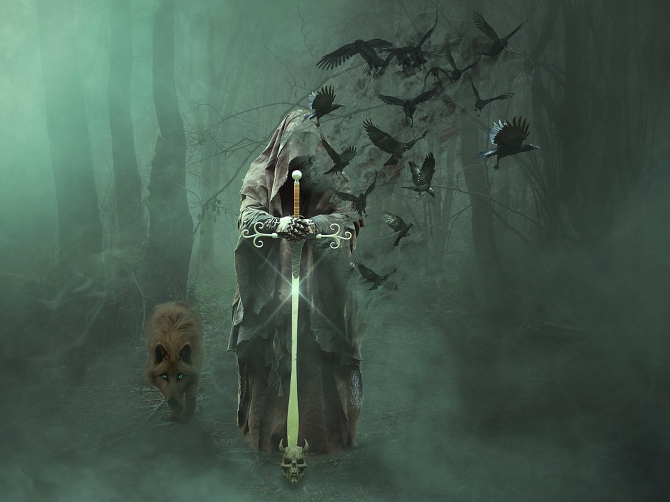 hooded figure in misty wood bearing a sword