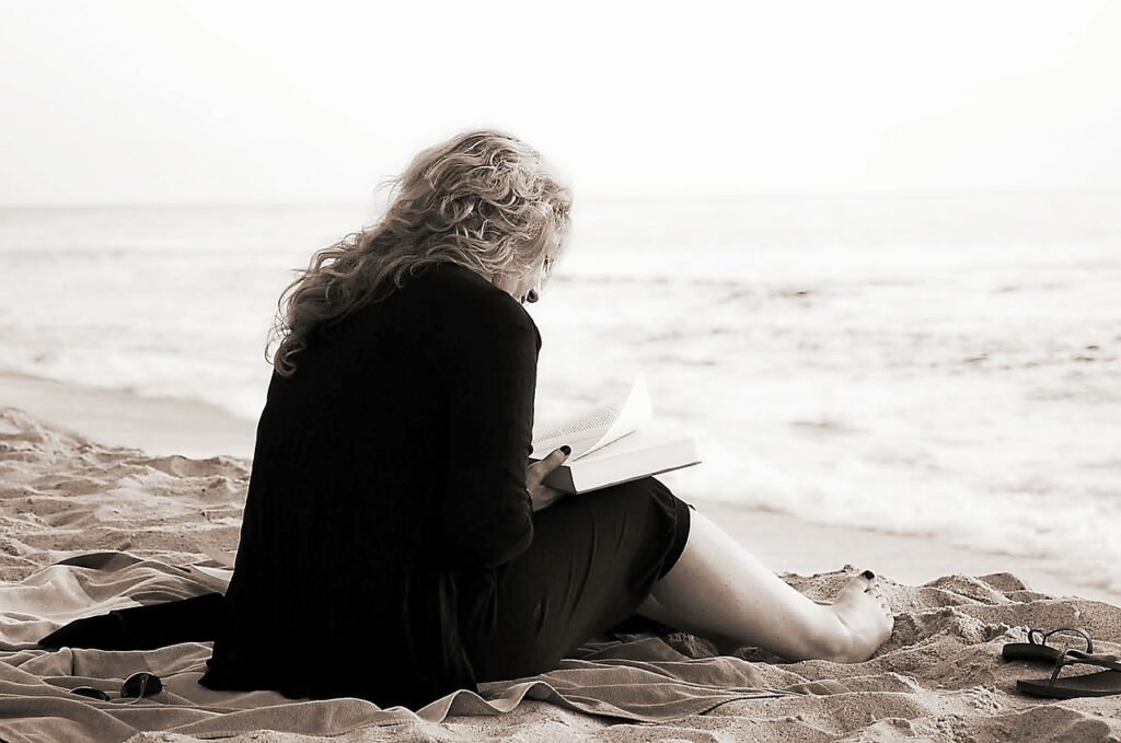 woman on beach reading
