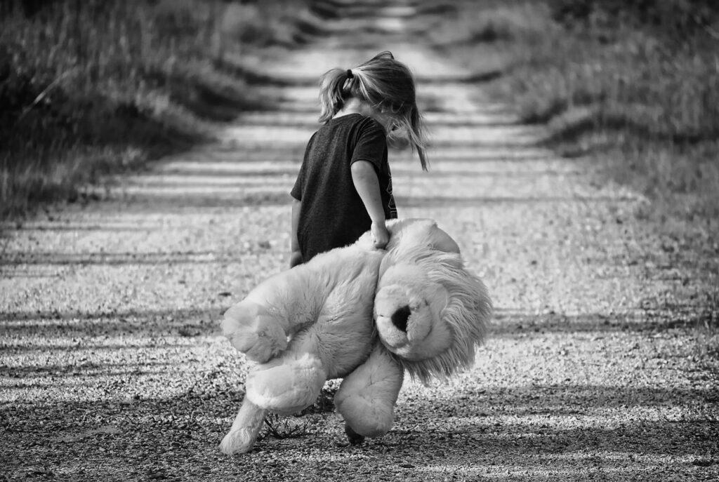 Little girl with toy lion on a track