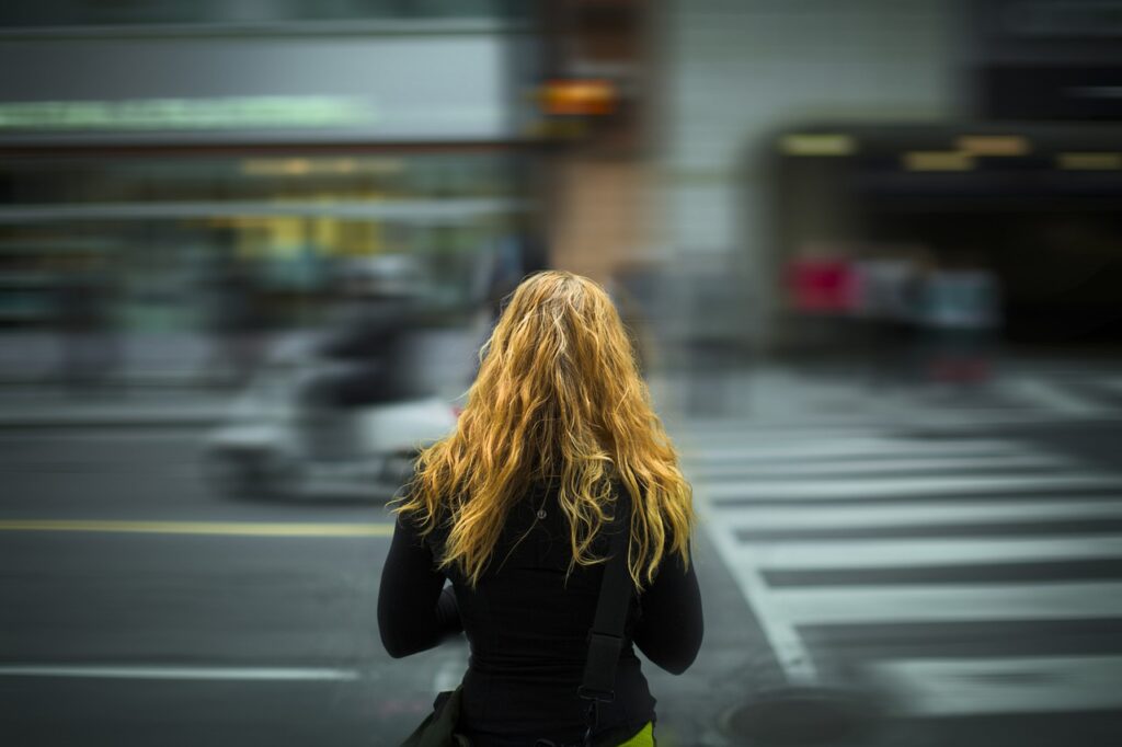 Young woman crossing street