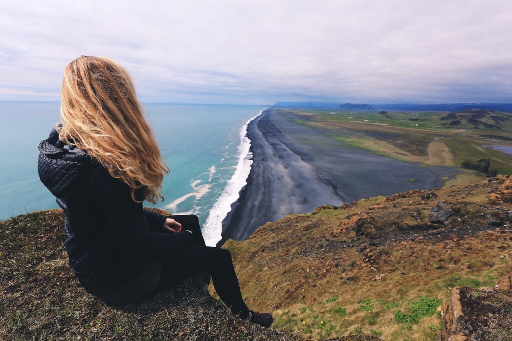 WOMAN ON CLIFF EDGE