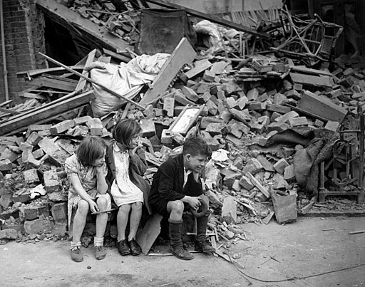 Children sitting at a bomb site